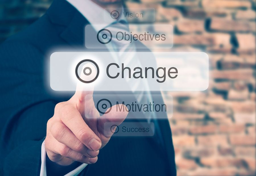 managing change Businessman pressing a Change concept button.