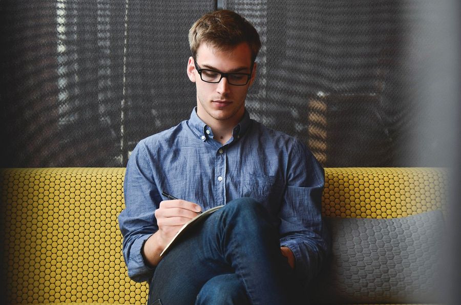 Millennial workforce member working on couch