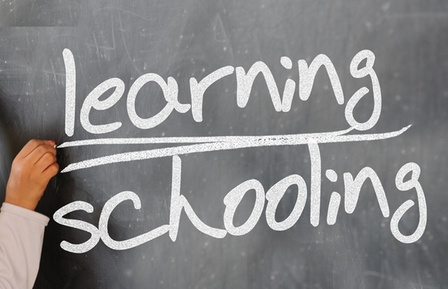 underlining learning over schooling on a chalkboard