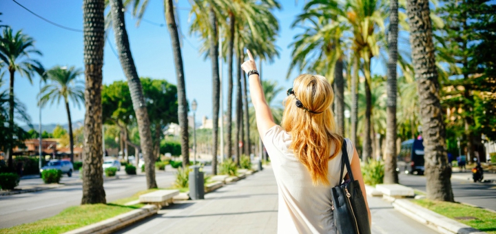 woman on vacation pointing and understanding the importance of work life balance