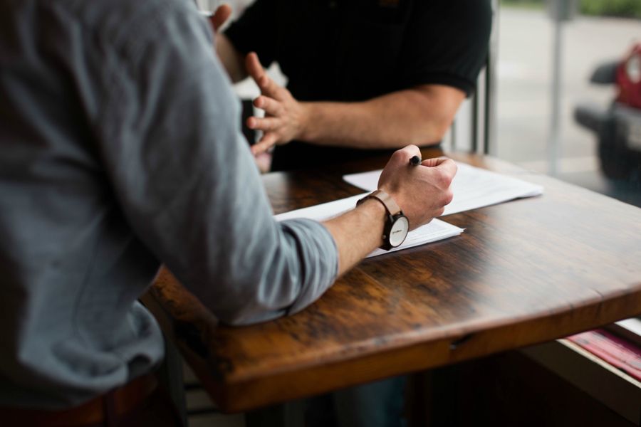 two men talking at desk about employee retention