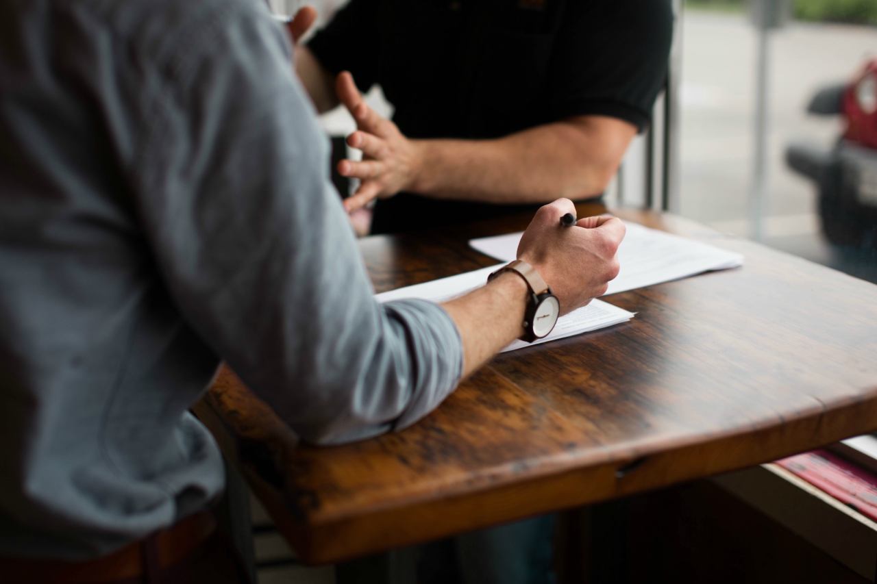 two men talking at desk about employee retention