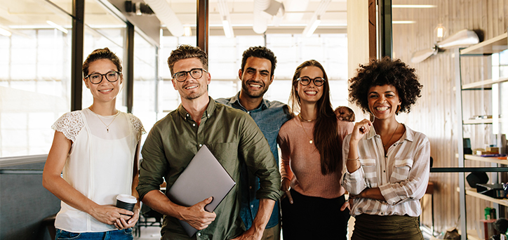 Smiling employees standing together