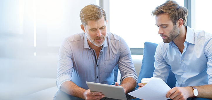 Two men looking at an iPad