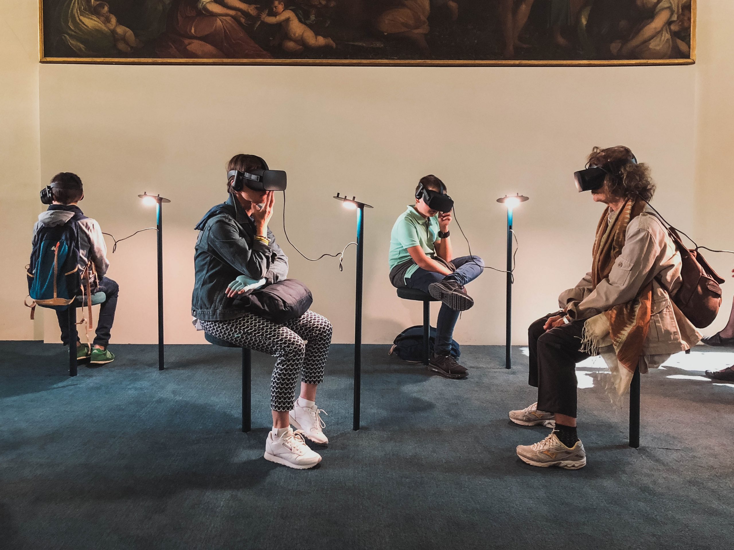 People in a museum exploring art with virtual reality headsets.