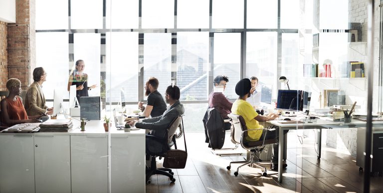 Modern office space with team members engaged in various tasks.