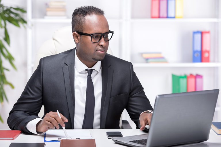 Serious businessman working at his desk with a laptop.