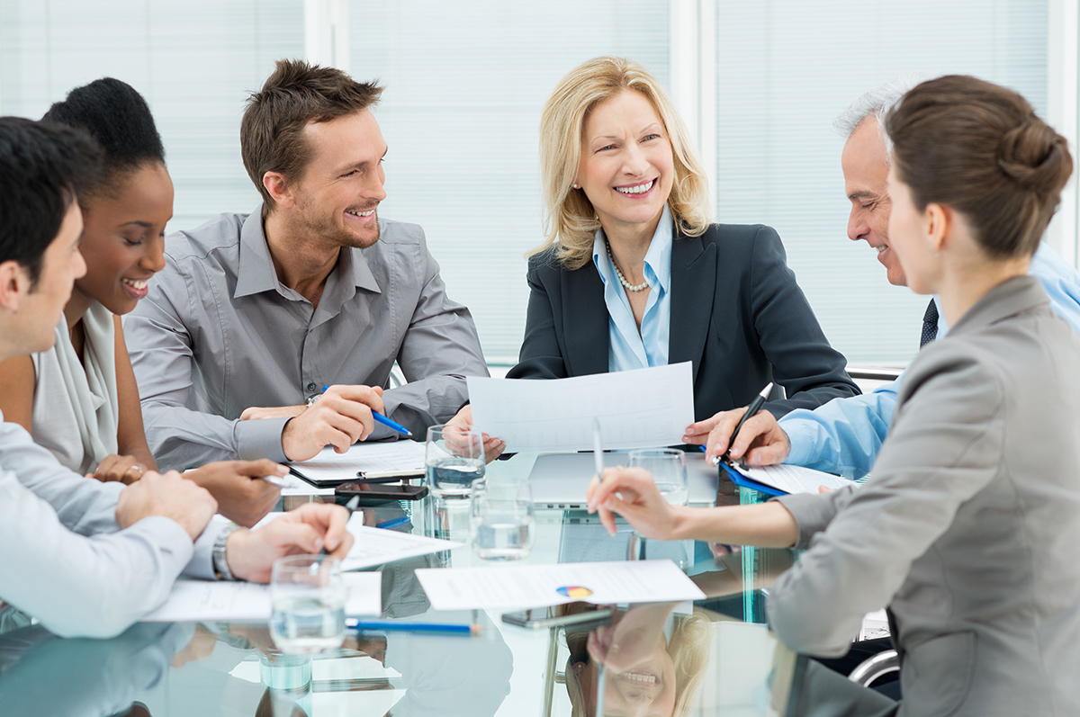 Diverse team engaging in a productive meeting around a table.