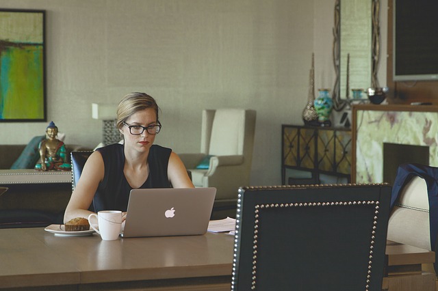 Focused woman working on laptop at an organized desk space for office ergonomics.