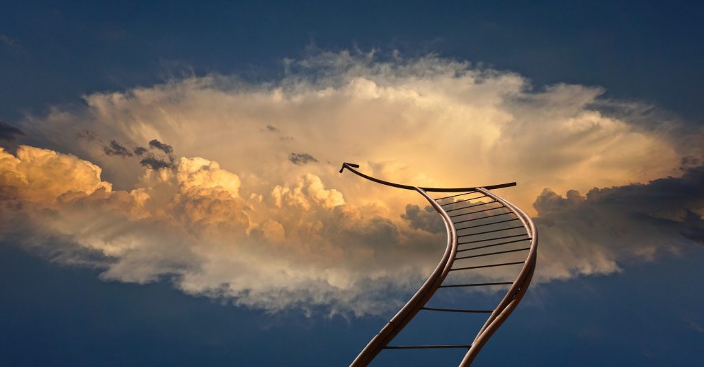 Rollercoaster track ascending into dramatic clouds, symbolizing career growth.