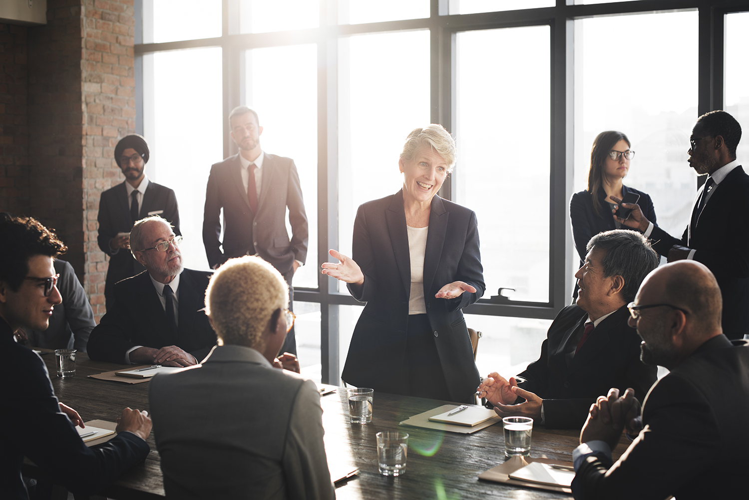 Confident female leader speaking at a diverse business meeting.