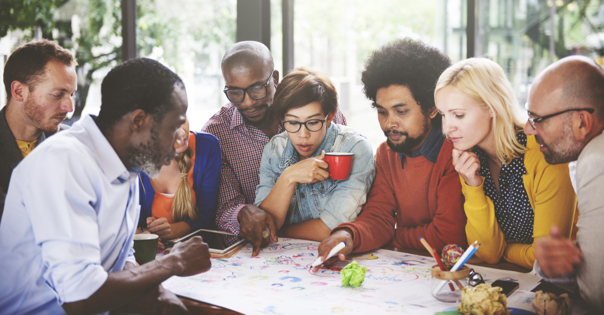 Diverse group of colleagues engaging in a creative brainstorming session at work.