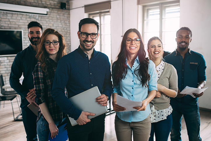 Confident diverse team with documents ready for a productive meeting.