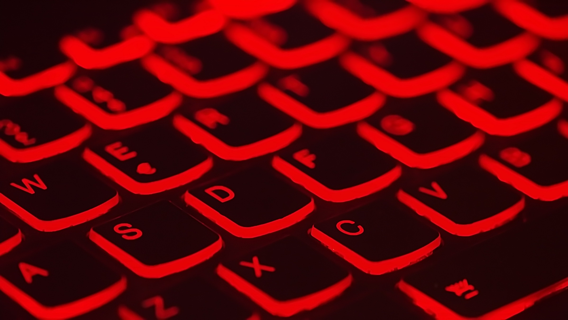 Close-up of backlit red keyboard keys, highlighting cybersecurity.